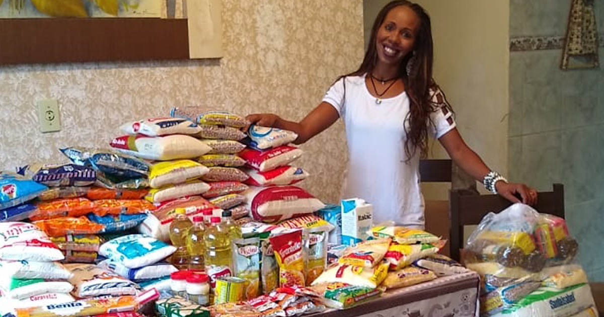 Vanessa ao lado das doações conquistadas pela Solutudo e parceiros